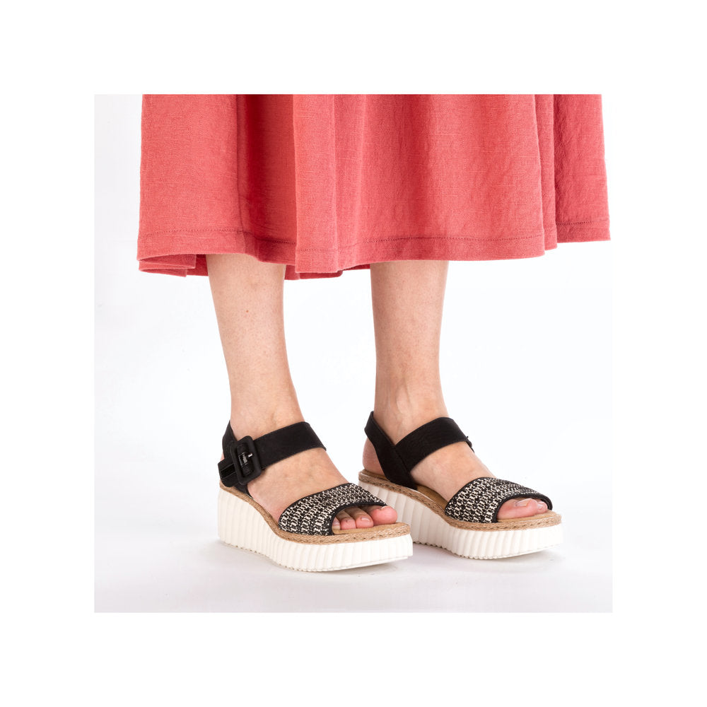 Rieker 69176-00 women's black buckle sandals with woven front straps and chunky platform soles.