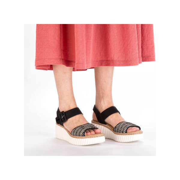 Rieker 69176-00 women's black buckle sandals with woven front straps and chunky platform soles.