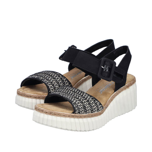 Rieker 69176-00 women's black buckle sandals with patterned front strap, platform heel, and adjustable ankle strap.