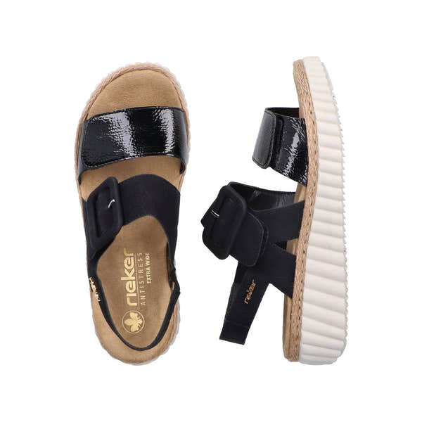 Rieker 69260-00 women's wide black buckle sandals with patent and fabric straps, cushioned footbed, and textured white outsole.