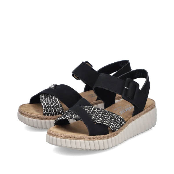 Rieker 69269-00 women's wide black touch fastening sandals with patterned and plain straps, cushioned footbed, and chunky white sole.