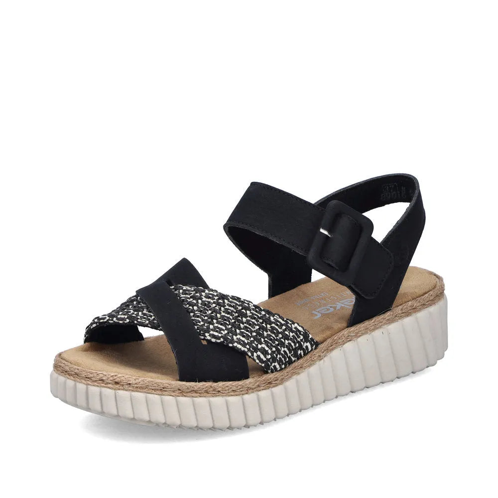 Rieker 69269-00 women's wide black touch fastening sandals with patterned and solid straps, cushioned insole, and textured white sole.