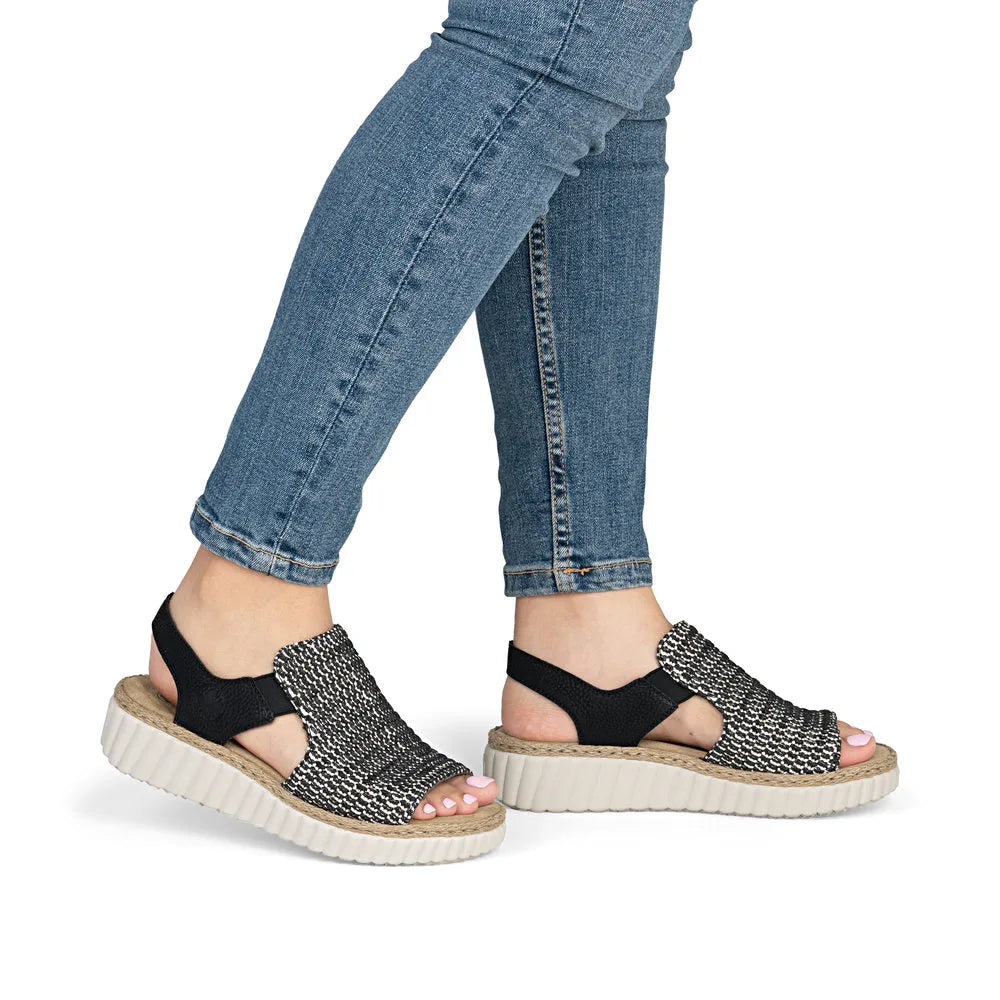 Rieker 69276-00 women’s wide black textile elasticated sandals with chunky sole and open toe design.