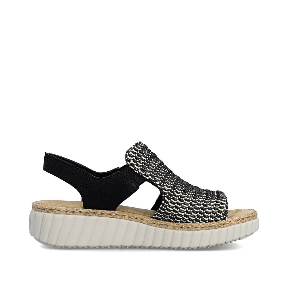 Rieker 69276-00 women's wide black textile elasticated sandals with cushioned white rubber sole and woven ankle strap.