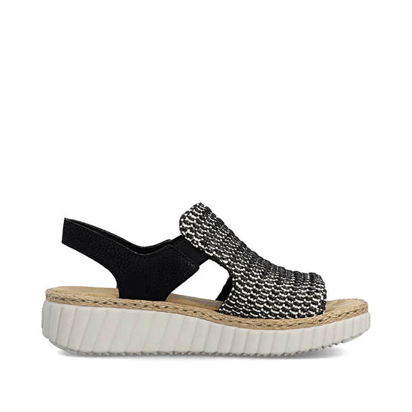 Rieker 69276-00 women's wide black textile elasticated sandals with cushioned white rubber sole and woven ankle strap.