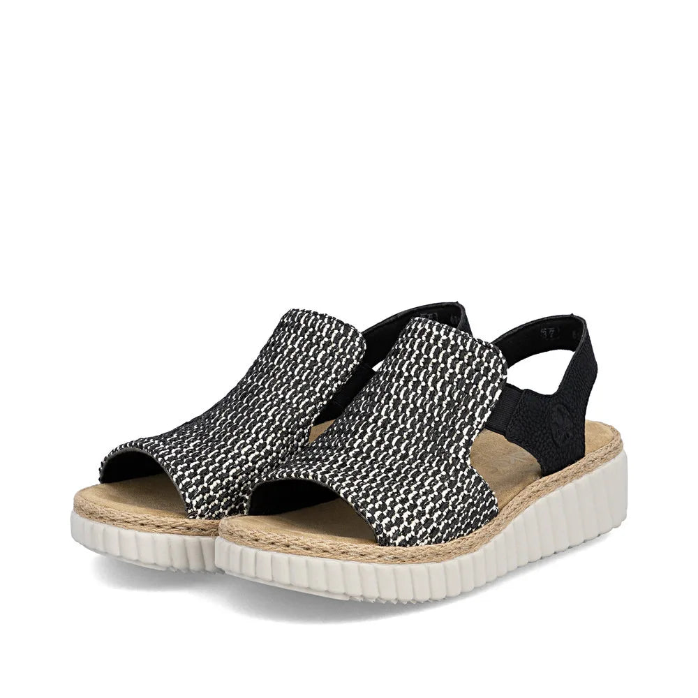 Rieker 69276-00 women's wide black textile elasticated sandal with cork insole and white sneaker-like sole.