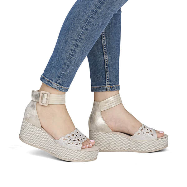 Rieker 69457-60 beige ladies wedge sandals with buckle ankle strap and perforated design, perfect for summer wear.