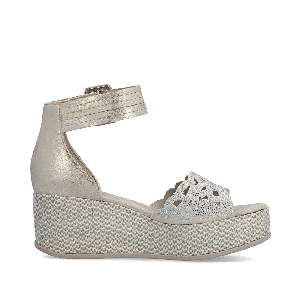 Rieker 69457-60 beige women's wedge sandals with buckle ankle strap and decorative cutout detail.
