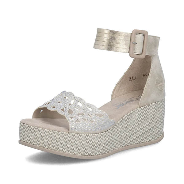 Rieker 69457-60 women's beige platform wedge sandal with lace upper, ankle strap with buckle, and decorative cutout detail.