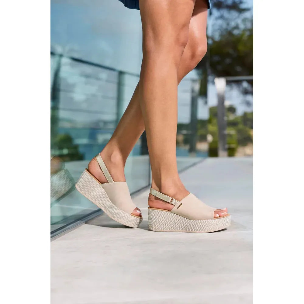 Rieker 69460-62 beige and pale gold slingback wedge sandals for women, open-toe design with ankle strap.