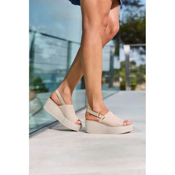 Rieker 69460-62 beige and pale gold slingback wedge sandals for women, open-toe design with ankle strap.
