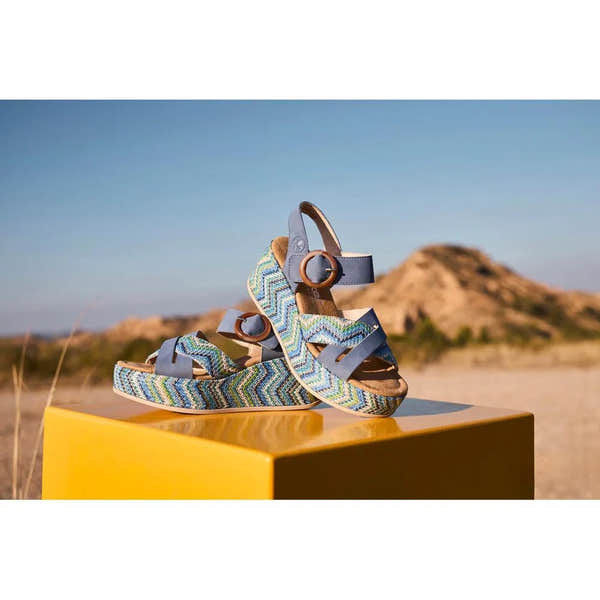 Rieker 69469-14 ladies navy touch fastening sandals with colorful zigzag patterned straps, ankle buckle, outdoor background.