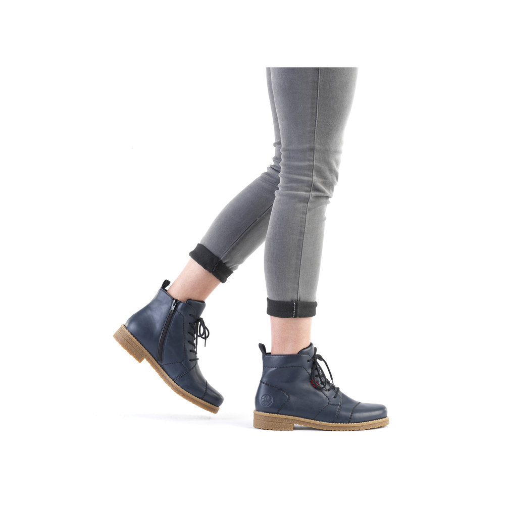 Rieker 73500-14 women's blue ankle boots with zip and lace-up closure, featuring a low heel and tan rubber sole.