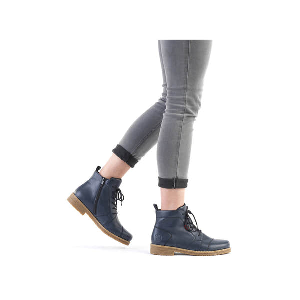 Rieker 73500-14 women's blue ankle boots with zip and lace-up closure, featuring a low heel and tan rubber sole.