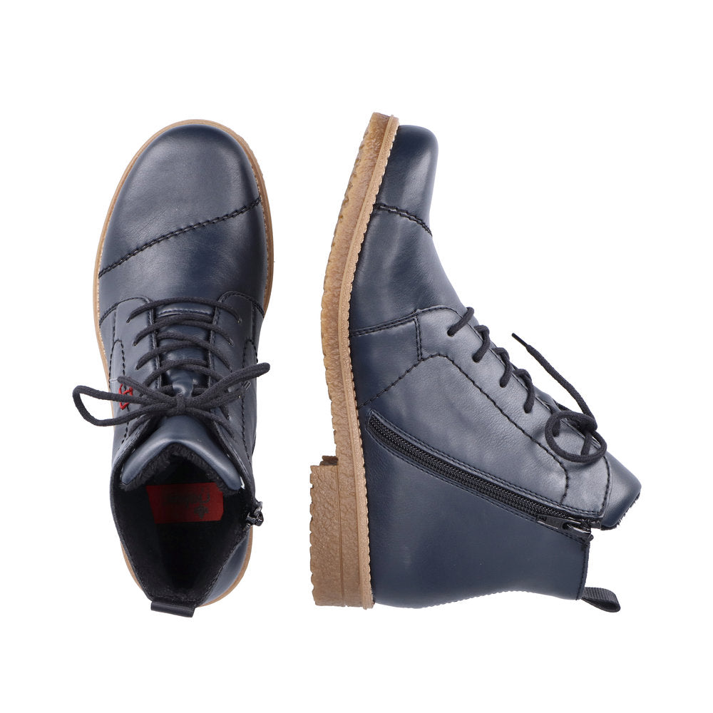 Rieker 73500-14 women's navy blue zip and lace ankle boots with tan sole, leather upper, and side zipper detail.