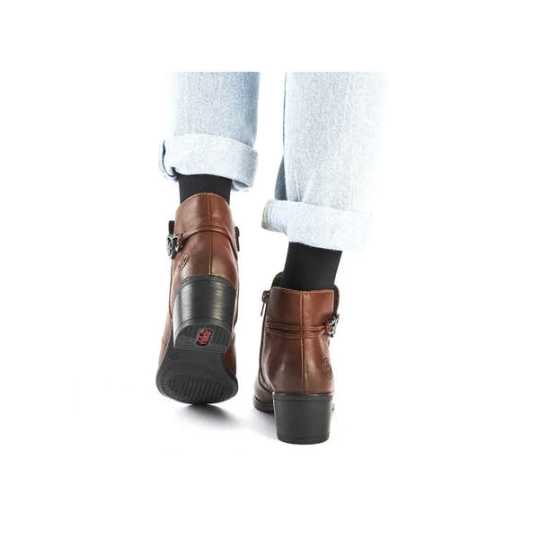 Rieker 73970-22 women's brown ankle boots with side zippers, chunky heels, and black socks, stylish and comfortable for fall wear.