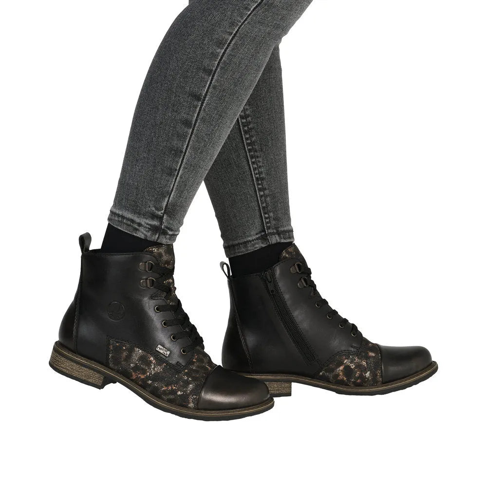 Rieker 74842-00 women's black leather ankle boots with lace and zip, water-resistant design, and leopard print accents.