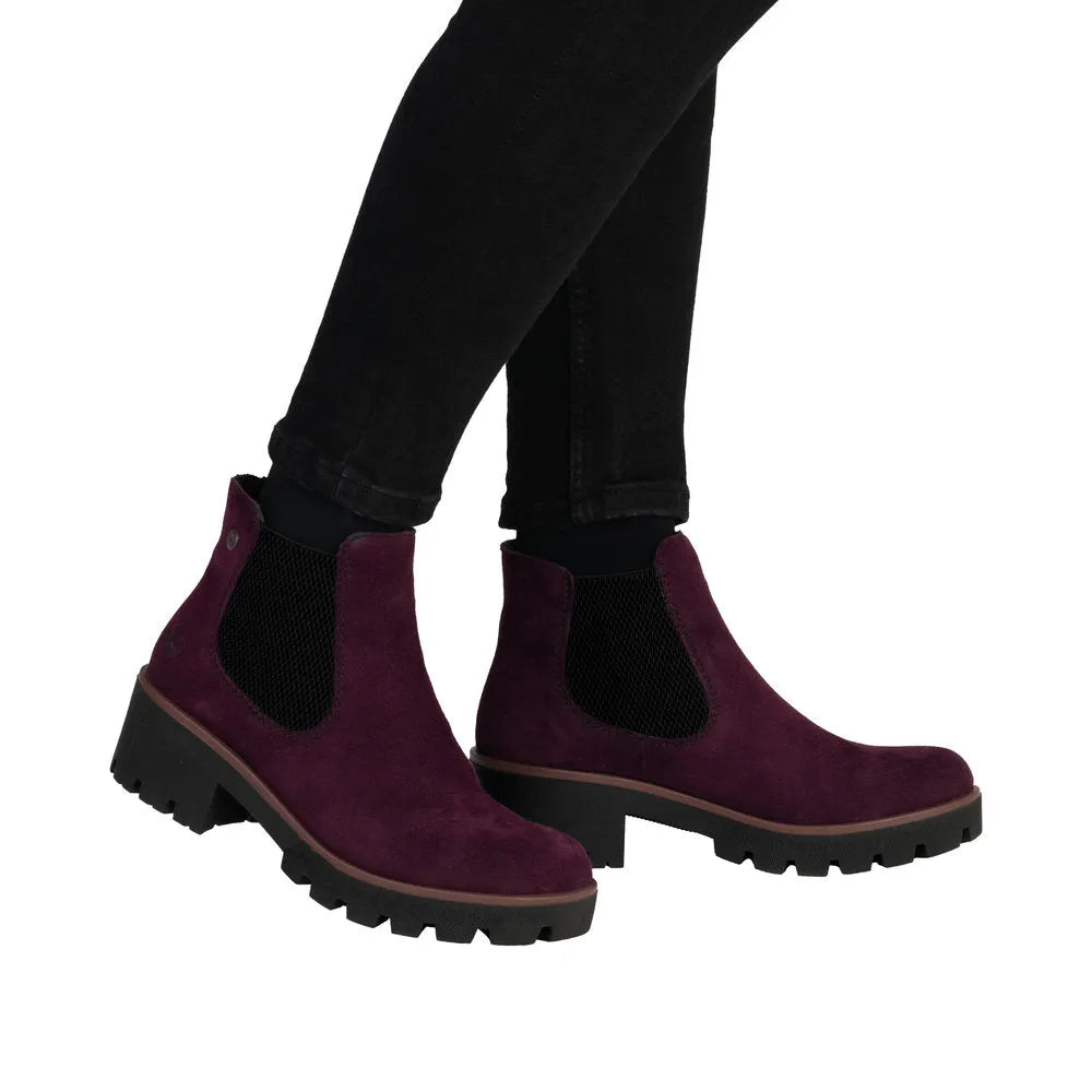 Rieker 79265-30 women's red suede slip-on ankle boots with black elastic side panels and chunky black soles.