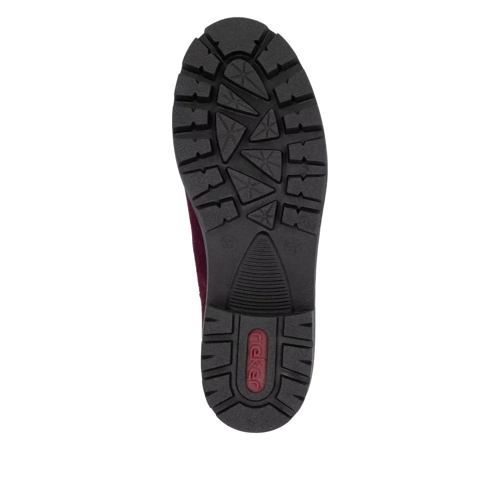 Rieker 79265-30 women's red suede slip-on ankle boots with rugged black rubber outsole and textured tread pattern.