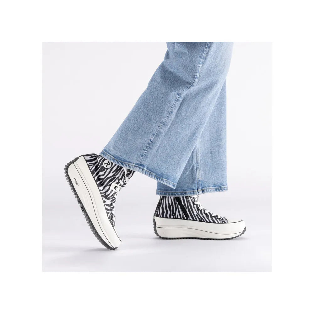Zebra textile vegan ankle boots with zip, lace-up design, chunky midsole, and black and white animal print.