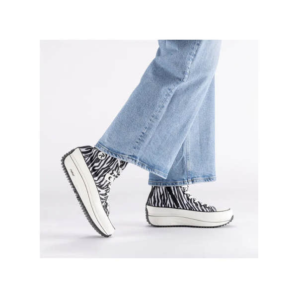 Zebra textile vegan ankle boots with zip, lace-up design, chunky midsole, and black and white animal print.