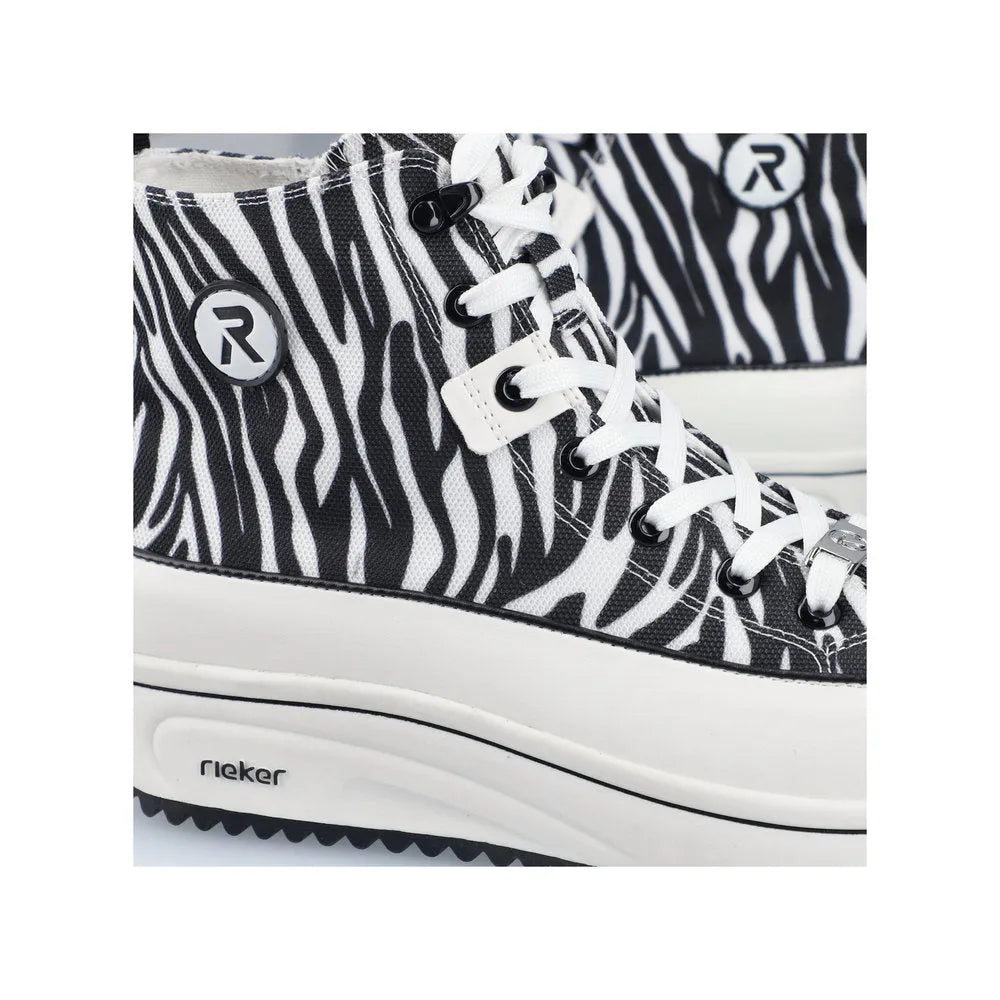 Black and white zebra print vegan ankle boots with laces, zipper, and Rieker logo accents.