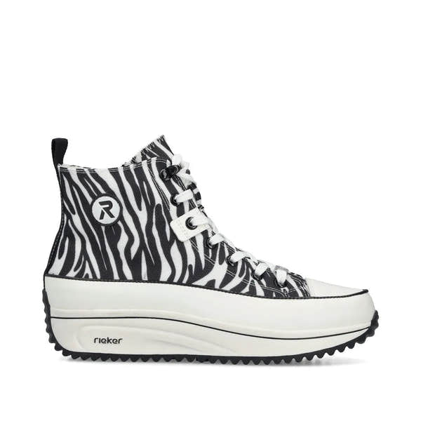 Black and white zebra-patterned vegan ankle boots with lace and zip closure, chunky sole, and Rieker branding.