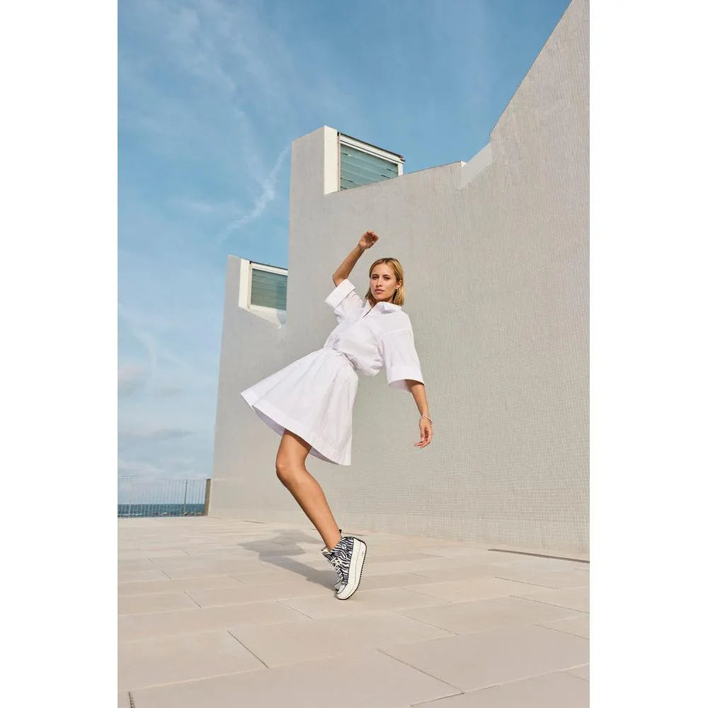 Women’s zebra-print vegan ankle boots with zip and lace details, in white and black, styled casually outdoors.