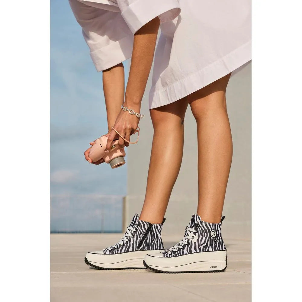 Women's zebra print vegan ankle boots with zip and lace, chunky platform sole, and high-top style.