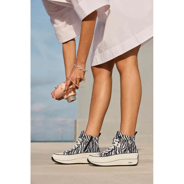 Women's zebra print vegan ankle boots with zip and lace, chunky platform sole, and high-top style.