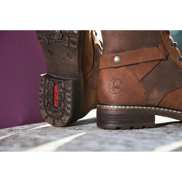 Rieker 94732-25 Ladies brown water-resistant knee-high boots with lace and zip closure, rugged sole, and stylish design.