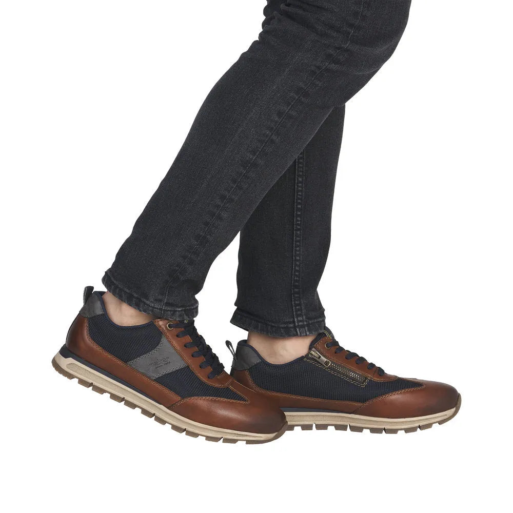 Rieker B0507-24 men's brown leather trainers with zip and lace-up closure, black mesh accents, rugged rubber sole, stylish casual footwear.