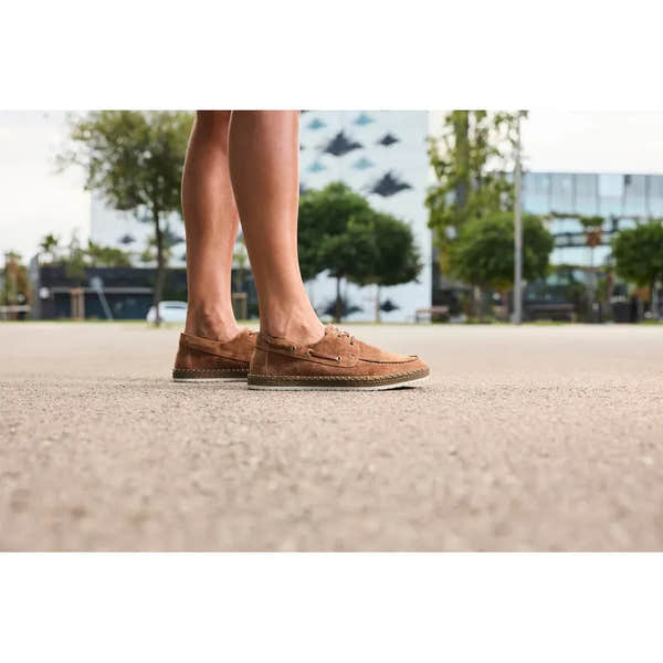 Rieker B5220-22 men's wide brown suede lace-up shoes on pavement with trees and modern buildings in background.