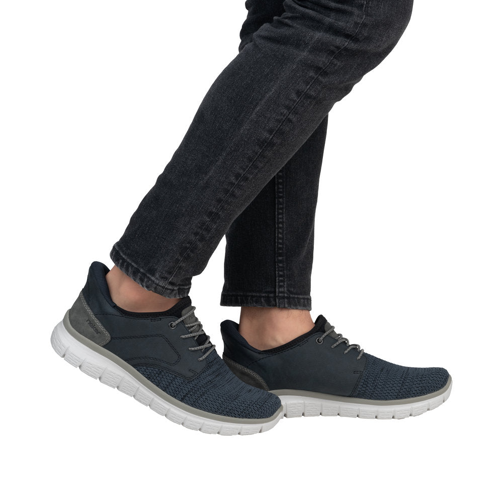 Men's navy blue Rieker B6658-14 wide-fit slip-on trainers with textile upper and white rubber sole.