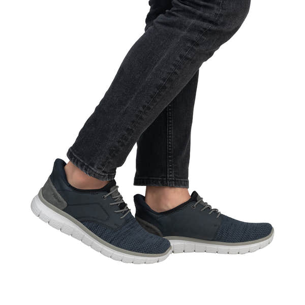 Men's navy blue Rieker B6658-14 wide-fit slip-on trainers with textile upper and white rubber sole.