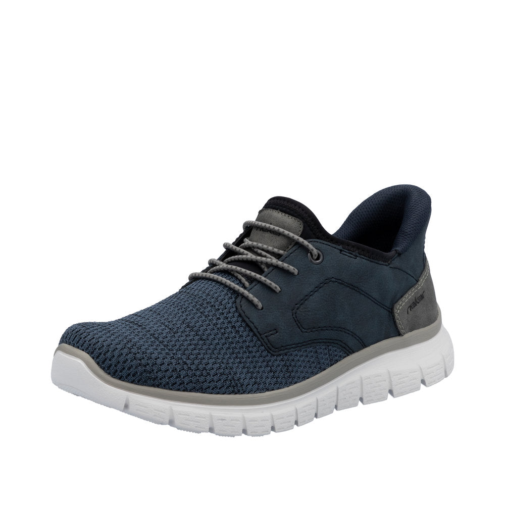 Rieker B6658-14 men's wide-fit navy textile slip-on trainers with cushioned white sole and lace-up closure.