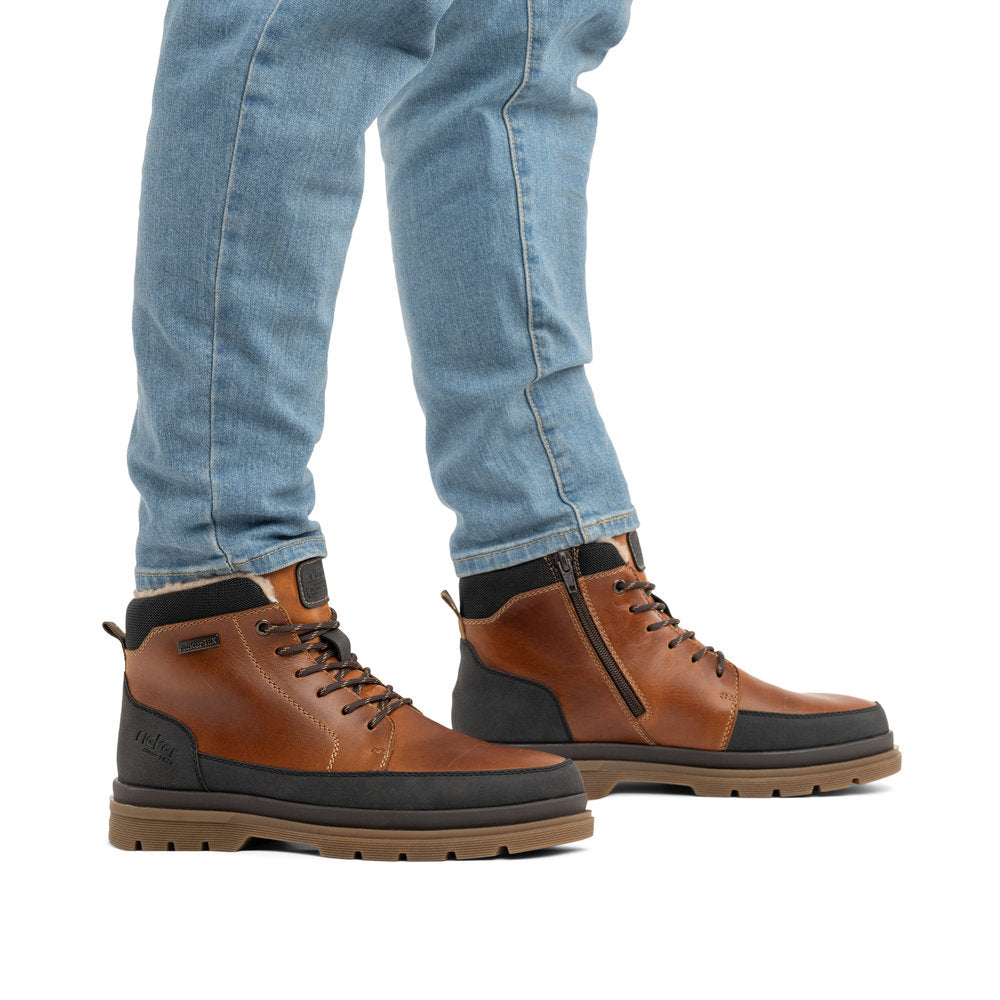 Rieker F7044-25 men's wide brown/black leather water resistant zip & lace ankle boots, on-foot lifestyle view.