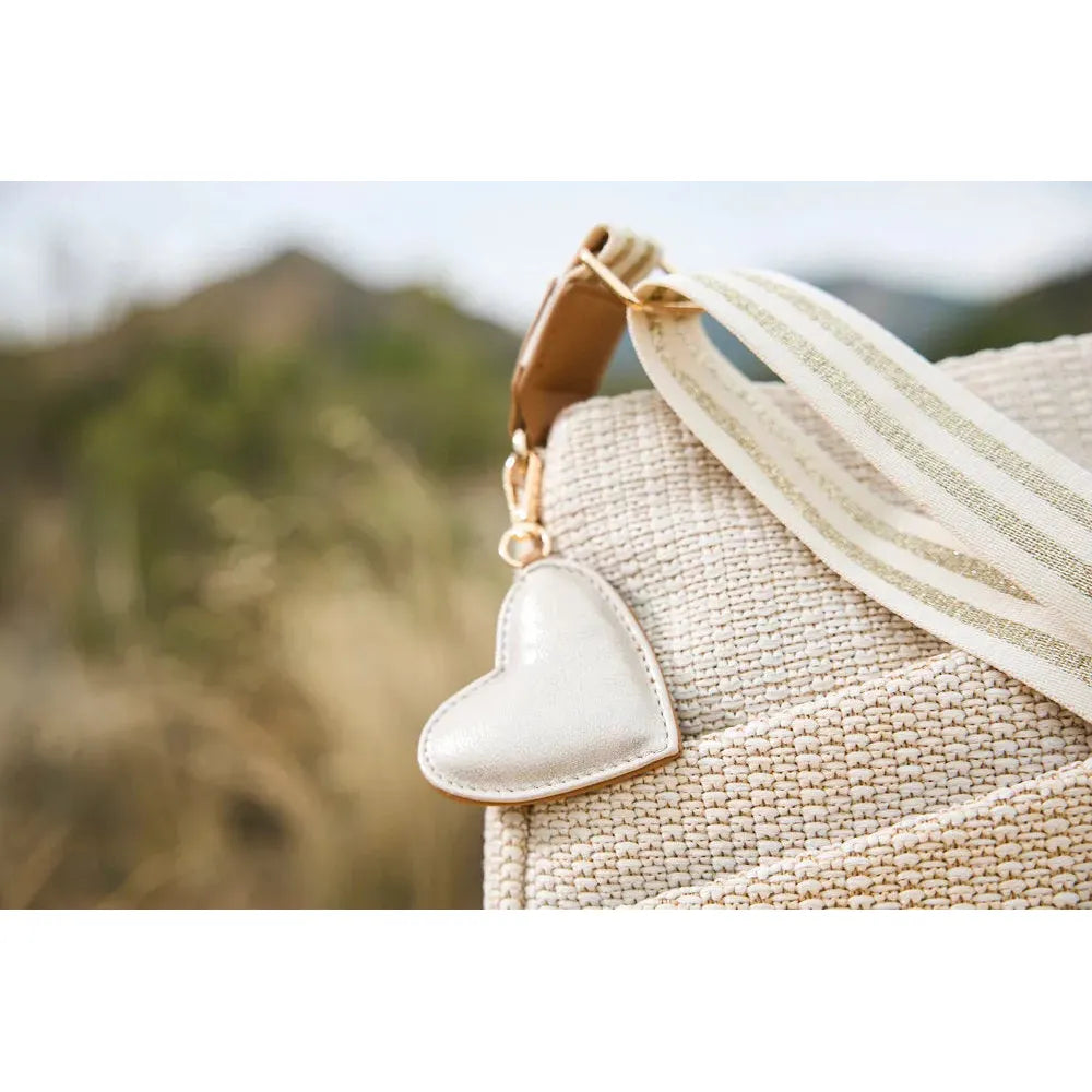 Rieker H1004-62 Pale Gold handbag with woven texture, heart-shaped charm, and striped strap, perfect for casual or chic outfits.