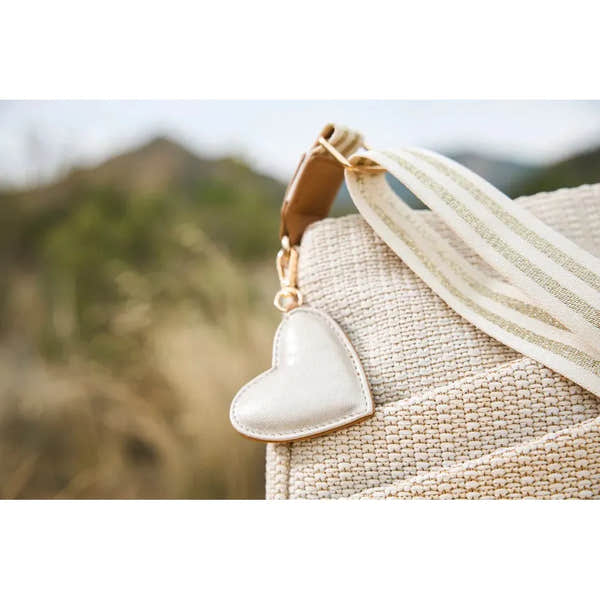 Rieker H1004-62 Pale Gold handbag with woven texture, heart-shaped charm, and striped strap, perfect for casual or chic outfits.