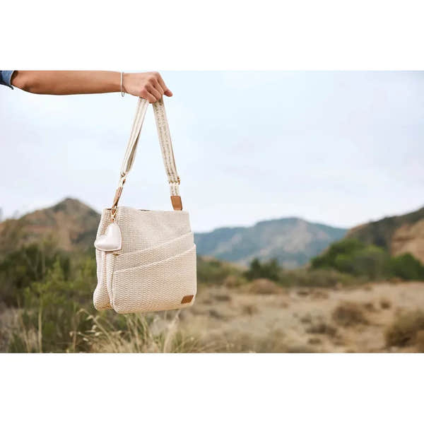 Rieker H1004-62 Pale Gold Handbag with adjustable strap and front pocket, outdoor background, stylish and lightweight accessory.