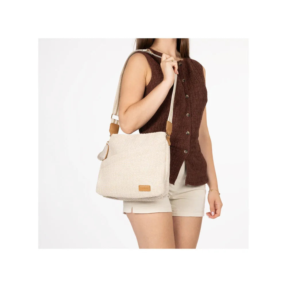 Rieker H1004-62 Pale Gold handbag with adjustable strap, woven texture, and leather accent, worn by a woman in casual outfit.
