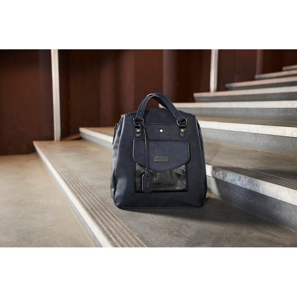 Rieker H1036-14 Ocean Navy & Black backpack, stylish everyday bag with front pocket and top handles, on a stairway.