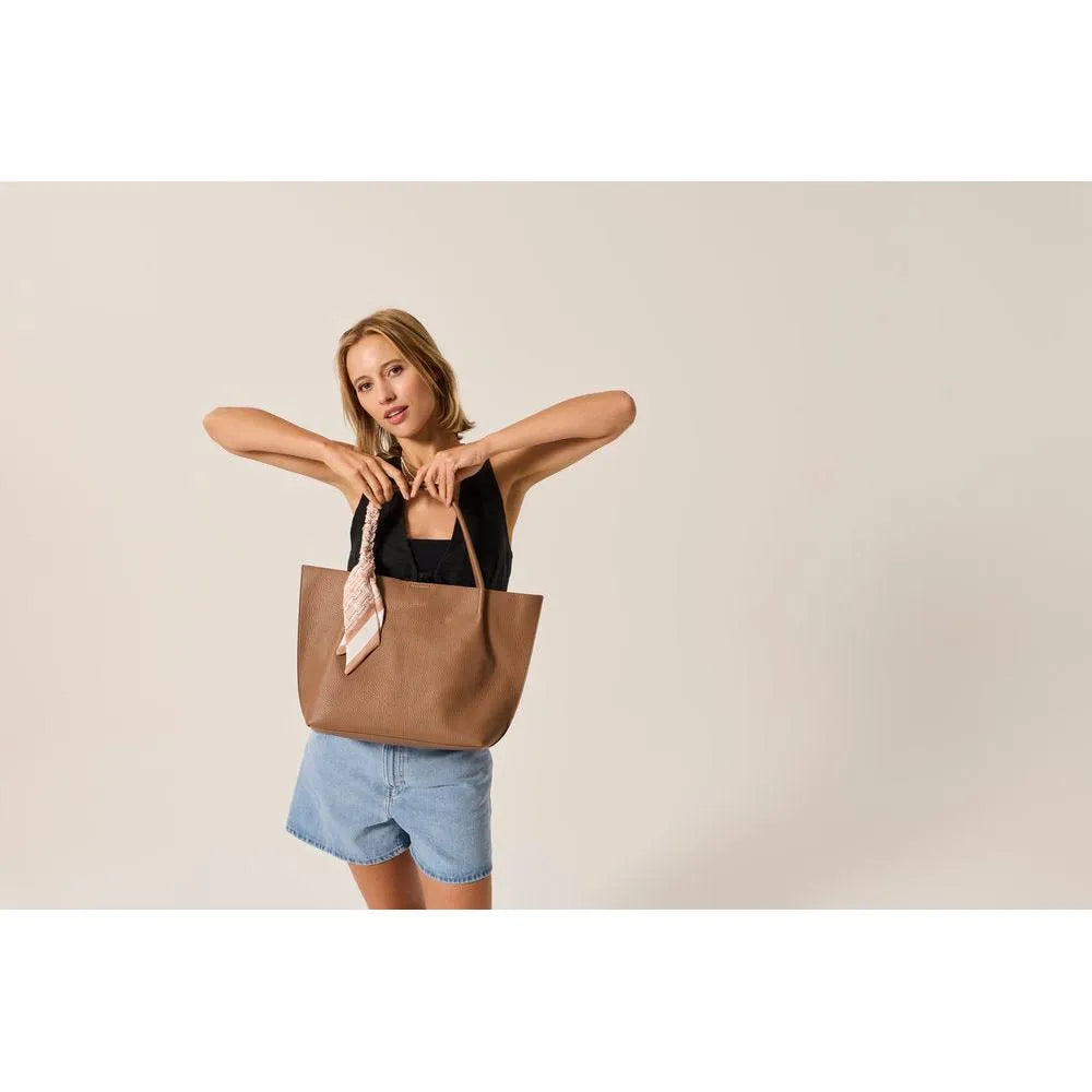 Rieker H1399-24 taupe handbag with shoulder straps and a decorative scarf, stylish and spacious for daily use.