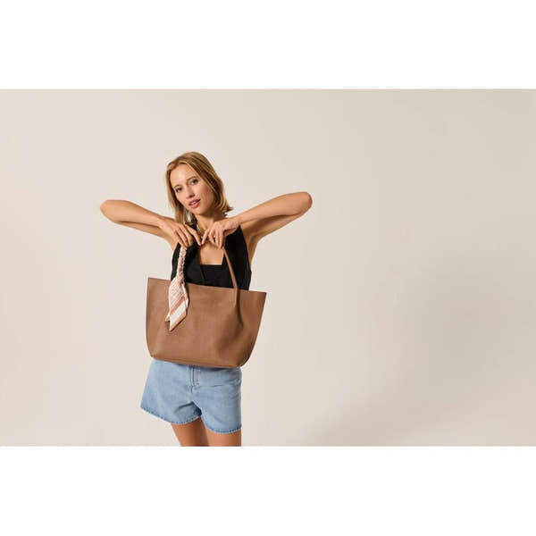 Rieker H1399-24 taupe handbag with shoulder straps and a decorative scarf, stylish and spacious for daily use.
