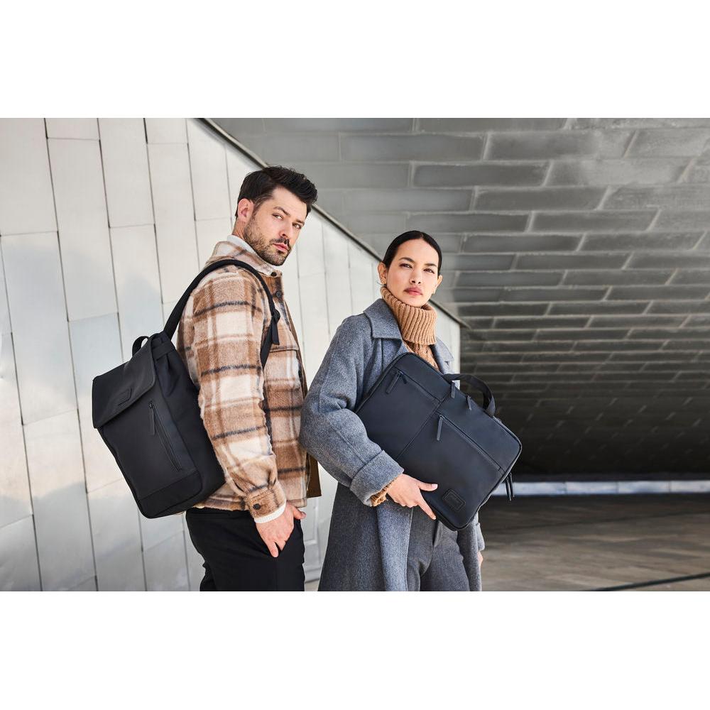 Rieker H5000-00 black business bag with multiple compartments, carried by stylish man and woman outdoors.