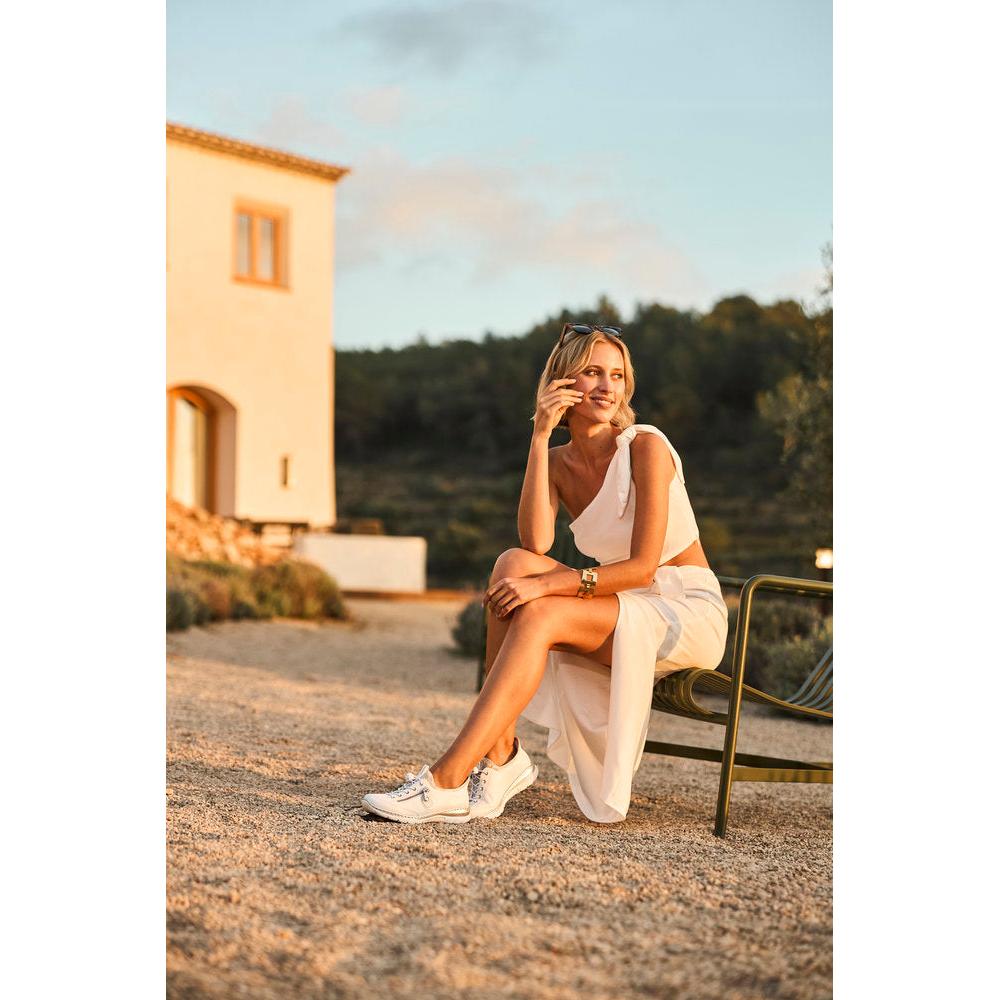 Rieker L32F1-80 womens white elasticated casual shoes, comfortable slip-on sneakers, outdoor setting, sunny weather.