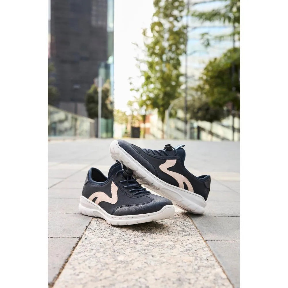 Black and beige elasticated slip-on shoes with white soles, casual style, outdoor urban setting.