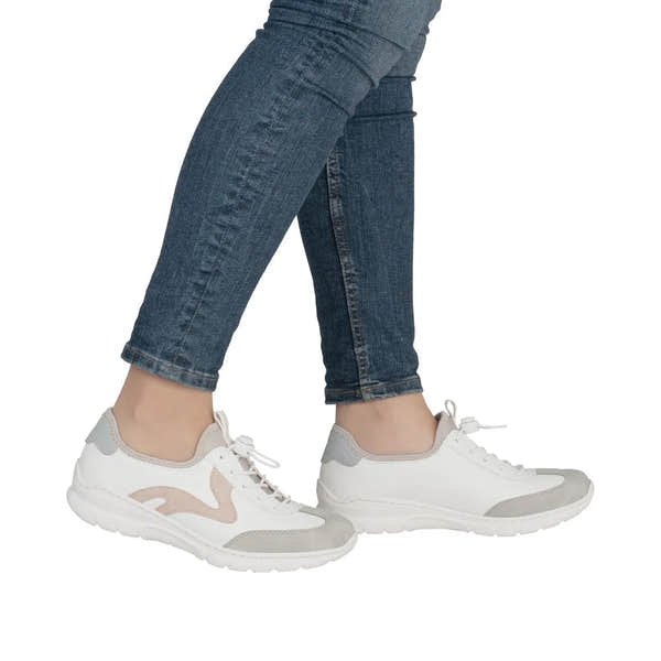 White and beige Rieker ladies' elasticated fastener shoes with grey accents, breathable materials, and a sporty, casual style.