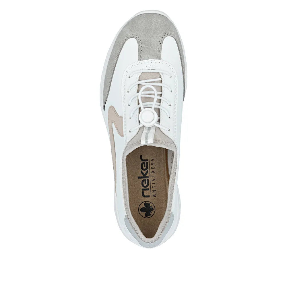 White and beige Rieker ladies' multi-elasticated fastener shoes, featuring suede and mesh materials with a sporty style.