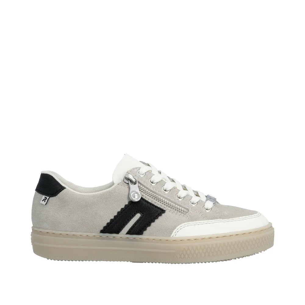 Rieker L5903-40 women's off-white suede sneakers with lace-up, zipper detail, black accents, and a beige rubber sole.